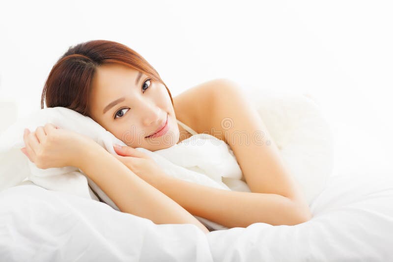 Beautiful asian woman relaxing on the bed