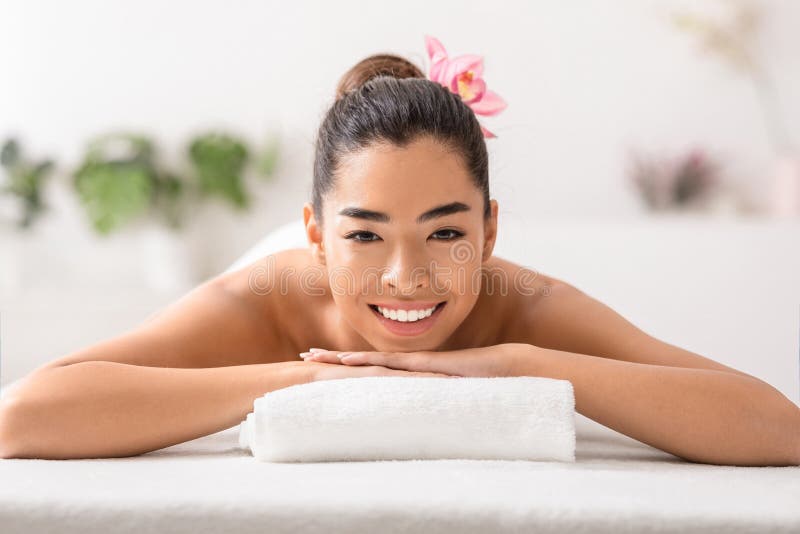 Beautiful Asian Woman Relaxing In Spa Salon Lying On Massage Table Stock Image Image Of Asian