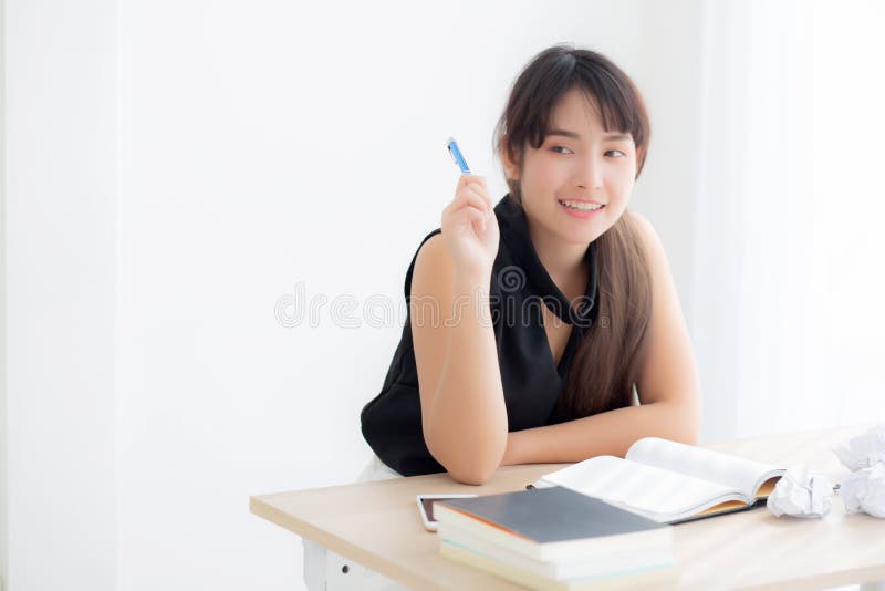 Beautiful asian woman writer smiling thinking idea writing on notebook diary with planning working on desk office royalty free stock photos Beautiful asian woman writer smiling thinking idea writing on notebook diary with planning working on desk office royalty free stock photos