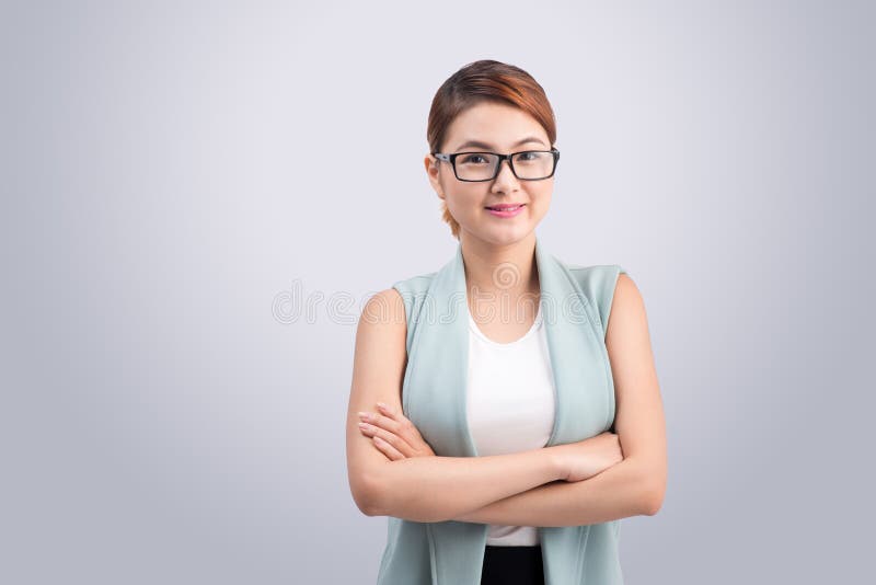 Beautiful asian young business woman on grey background.