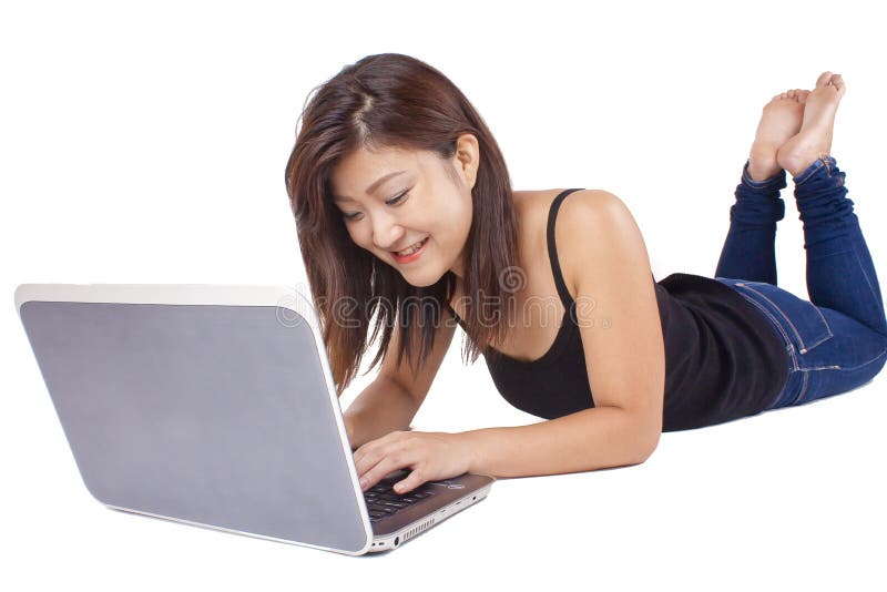 Beautiful Asian young woman typing on laptop