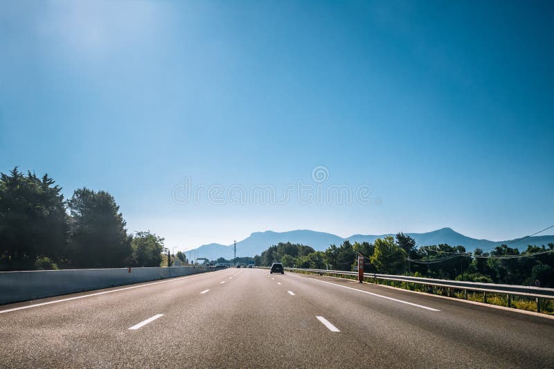 Beautiful asphalt freeway, motorway, highway ander sunny clear sky. Travel road concept.