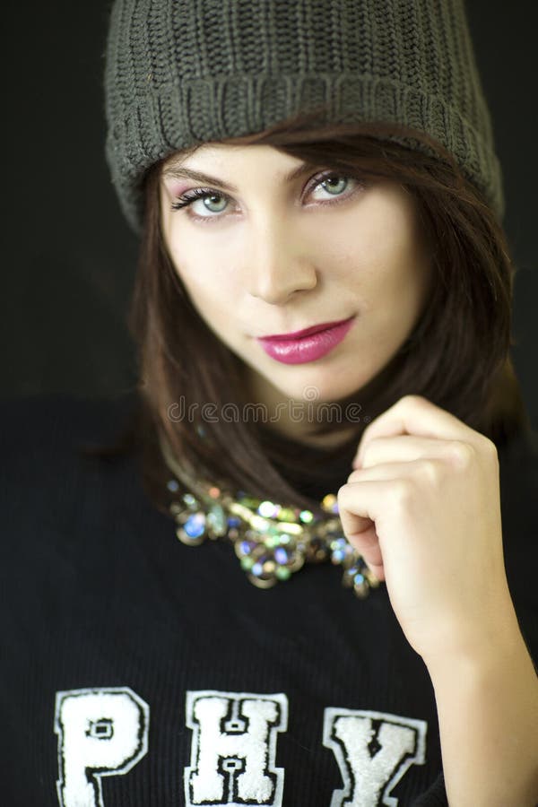 A beautiful auburn haired blue eyed woman with a knit hat and black shirt studio shot. stock images A beautiful auburn haired blue eyed woman with a knit hat and black shirt studio shot. stock images