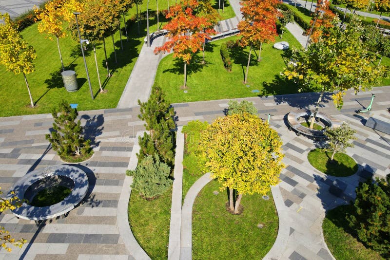 Beautiful autumn park with picturesque yellow orange trees. View from drone in leaf fall, details elements. Autumn streets in the stock photo