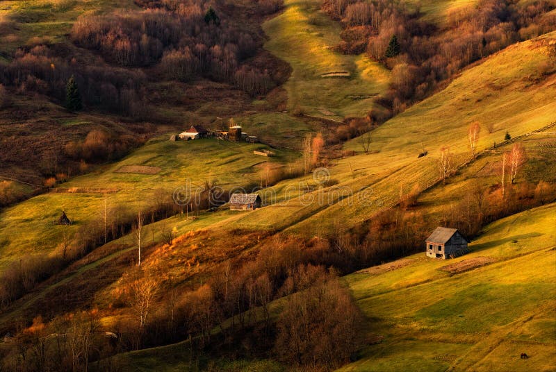 A beautiful autumn rural landscape with lonely houses, sunny hills and small horse. Carpathian rolling landscape on sunset in autu royalty free stock images A beautiful autumn rural landscape with lonely houses, sunny hills and small horse. Carpathian rolling landscape on sunset in autu royalty free stock images