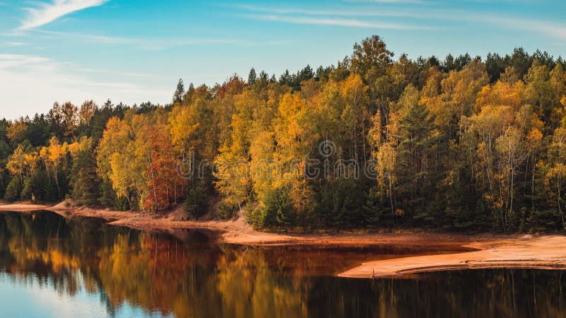 Beautiful autumn view of the iron mine lake colored red at Bad Muskau Park, Poland site