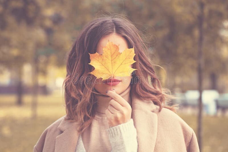 Beautiful Autumn Woman with Autumn Leaves