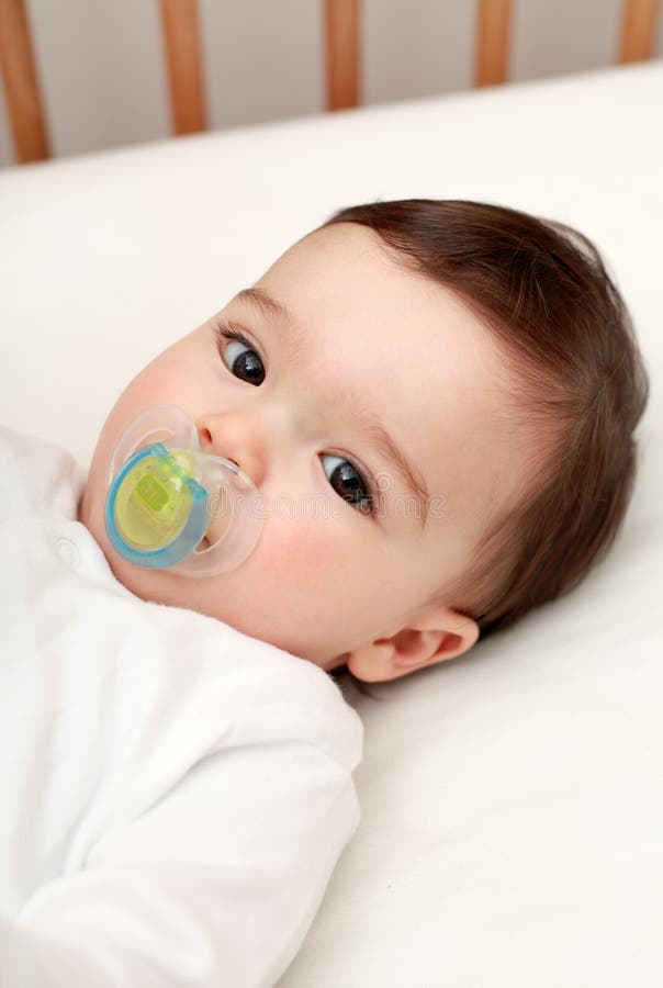 Beautiful baby with dummy stock image. Image of adorable 24725587