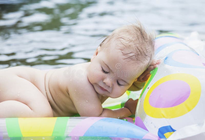 Baby Floating in the Middle of the Sea Stock Photo Image of
