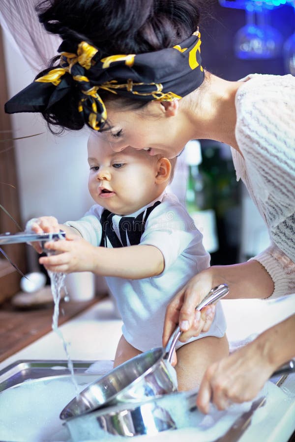 Photo of a beautiful baby help with washing