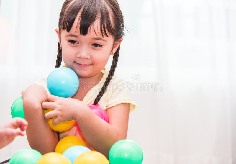 Beautiful baby kids girl kindergarten playing colorful ball royalty free stock photography Beautiful baby kids girl kindergarten playing colorful ball royalty free stock photography