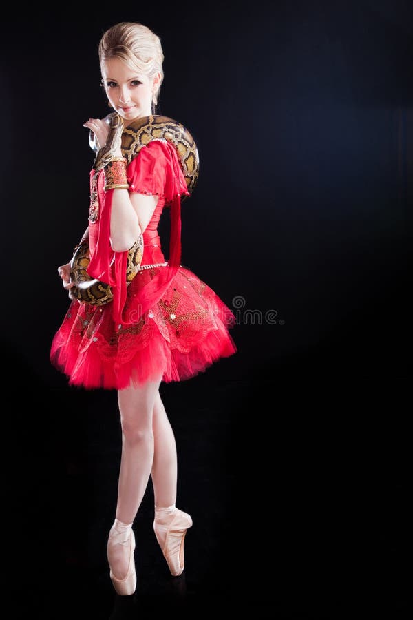 Beautiful ballerina girl in a red tutu with python