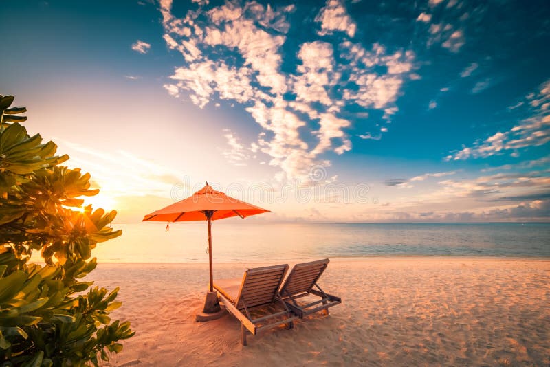 Beautiful beach sunset with sun beds and relaxing mood