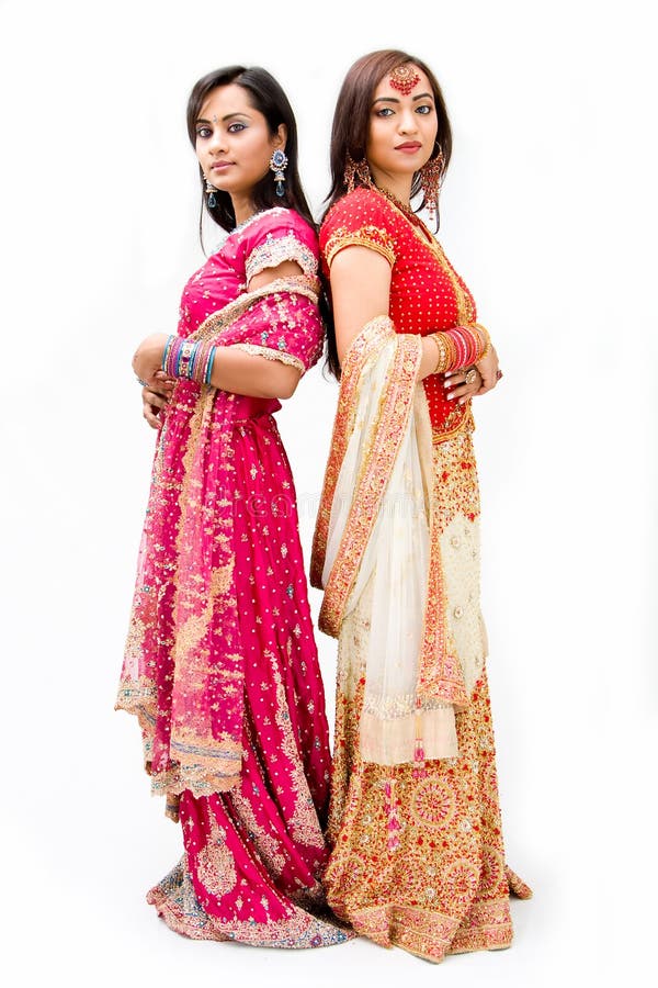 Two beautiful Bangali brides in colorful dresses, isolated. Two beautiful Bangali brides in colorful dresses, isolated