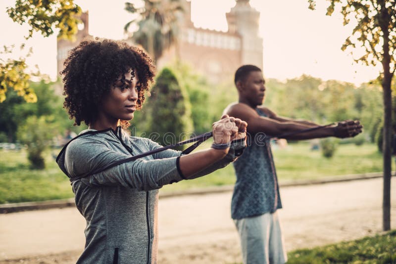 Black couple doing exercise outdoors