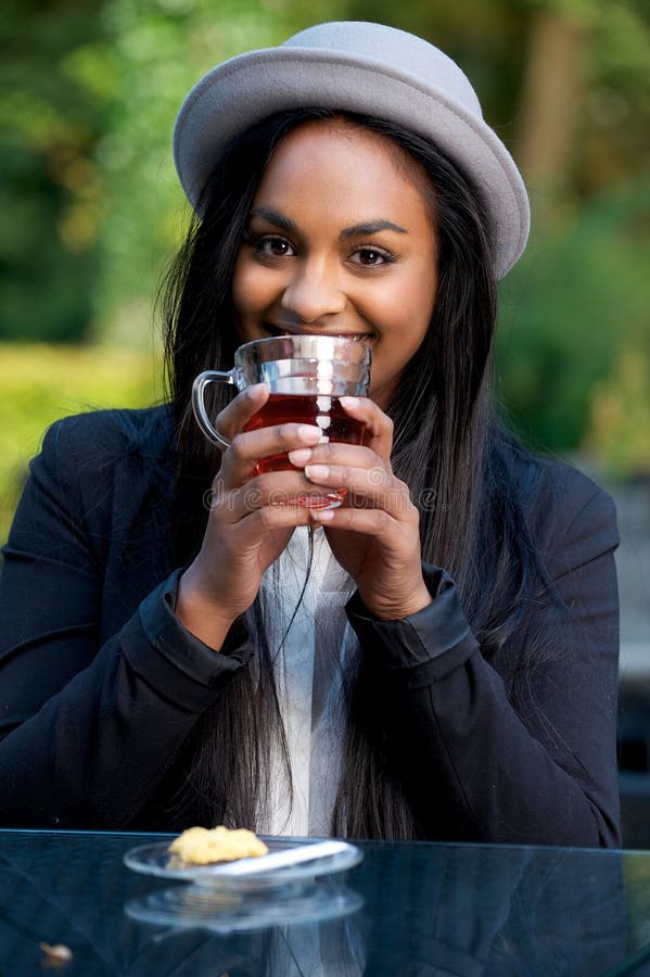 Beautiful Black Girl Smiling and Drinking Tea