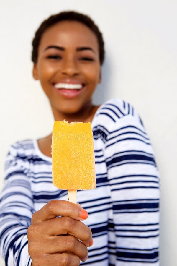 Beautiful black girl smiling and holding ice cream