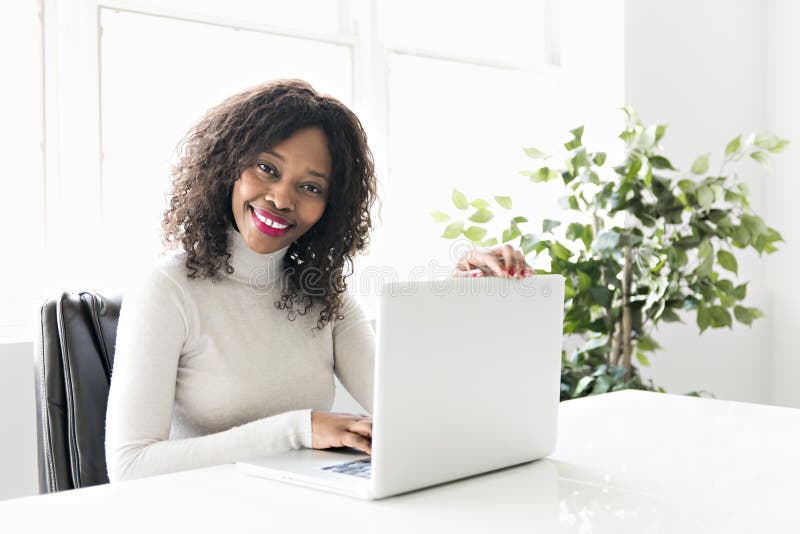 Beautiful black woman working on self employee office stock photo Beautiful black woman working on self employee office stock photo