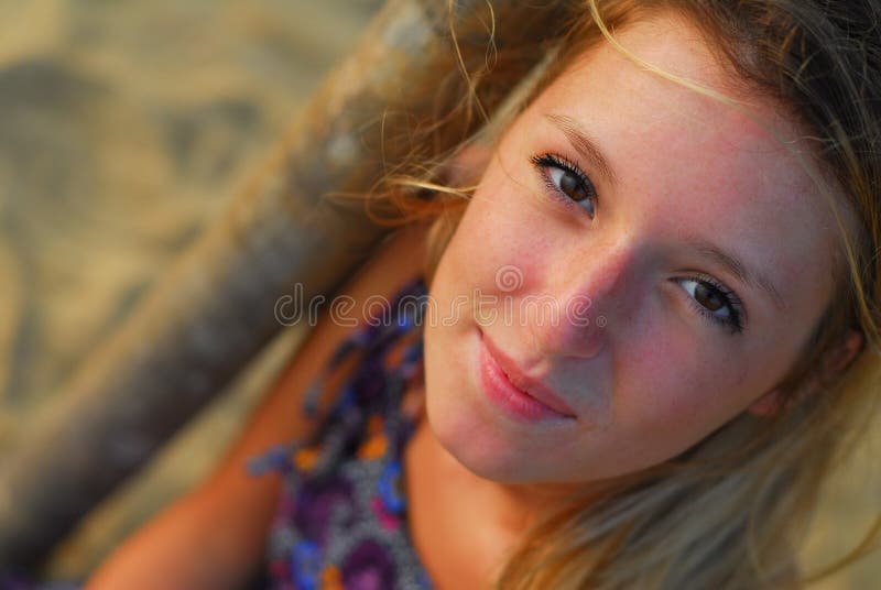 Beautiful blond girl smiling at camera