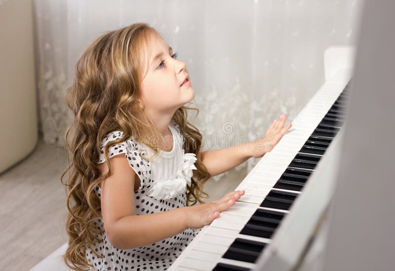 Beautiful Blond Little Girl Playing Piano Stock ...
