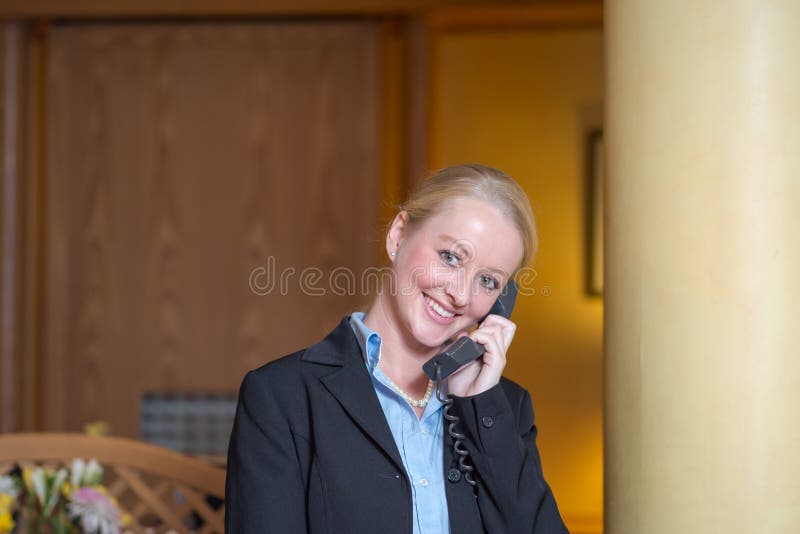 Beautiful blond receptionist answering a telephone