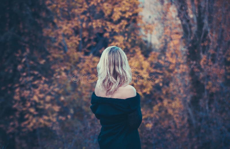 Beautiful blond woman in autumn park