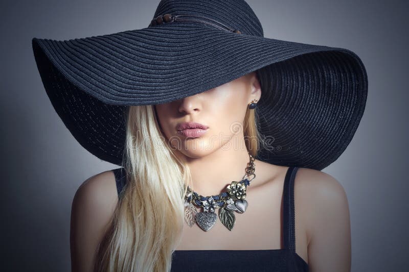 Beautiful Blond Woman in Black Hat.Lady in Jewelry