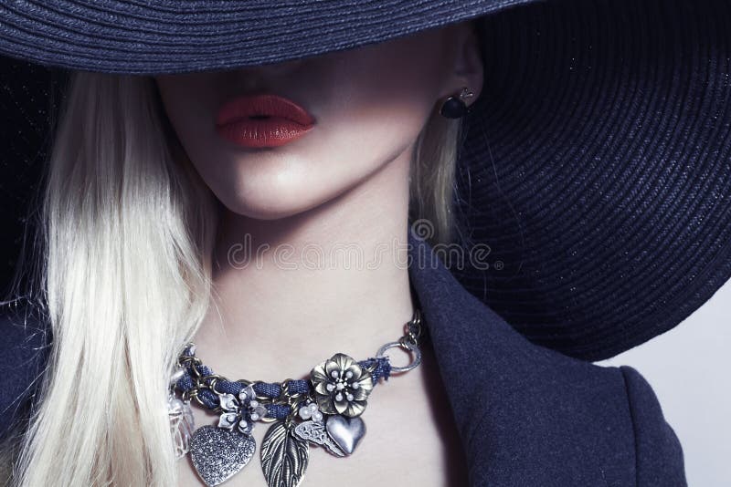 Beautiful Blond Woman in Black Hat.Spring Jewelry