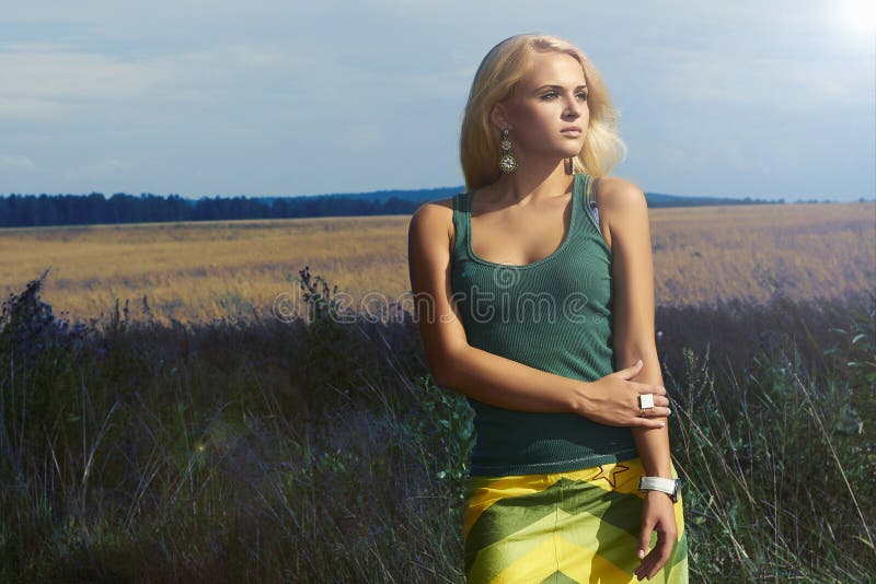 Beautiful Blond Woman on the field.Summer.Flowers