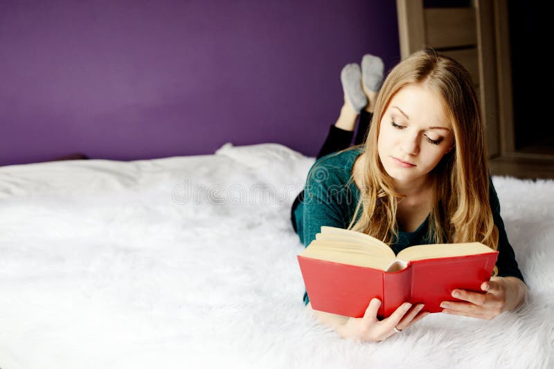 Beautiful blond woman reading a book