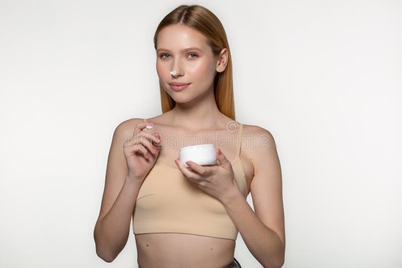 Beautiful blond woman tender jar of moisturizer cream. Close-up fresh young woman face. Isolated on white royalty free stock images Beautiful blond woman tender jar of moisturizer cream. Close-up fresh young woman face. Isolated on white royalty free stock images