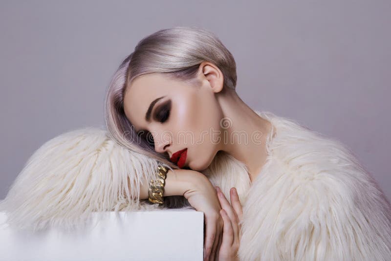 Beautiful blond young woman in white fur royalty free stock photos Beautiful blond young woman in white fur royalty free stock photos