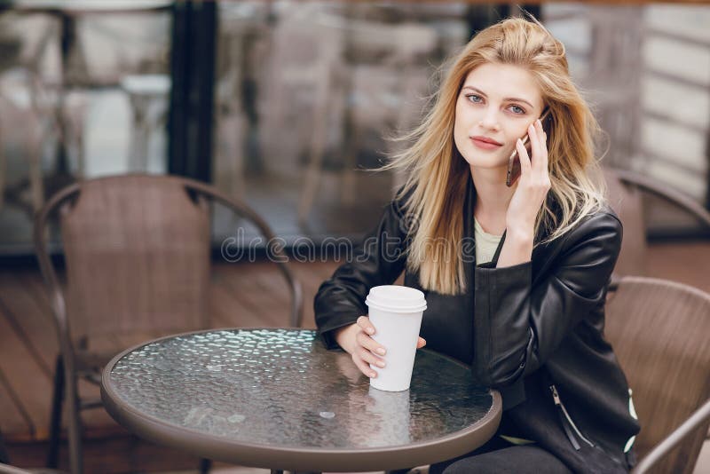 Beautiful blonde in cafe stock photo. Image of message - 91747838