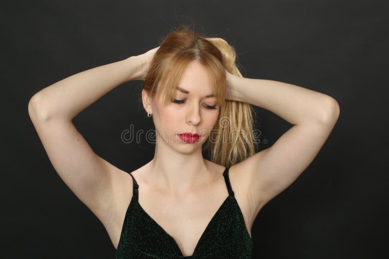 Beautiful blonde european girl with blue eyes posing in studio on isolated background. Style, trends, modeling, fashion concept.