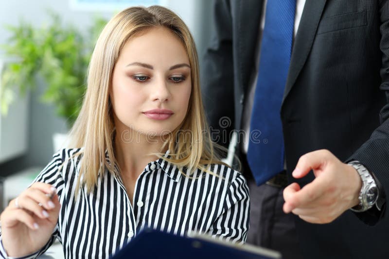 Beautiful blonde female clerk talking with male colleague royalty free stock photos Beautiful blonde female clerk talking with male colleague royalty free stock photos