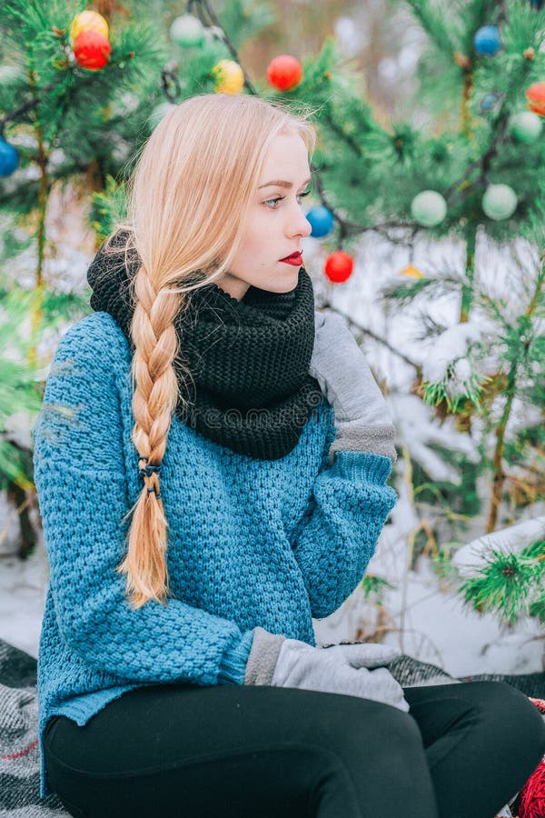 Beautiful blonde girl braids braid, knitted sweater, Winter magic day, the effect retro photo, grain