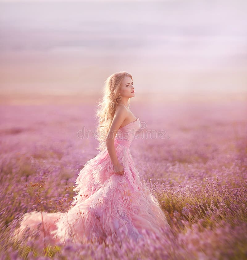 Beautiful blonde girl in a field of lavender