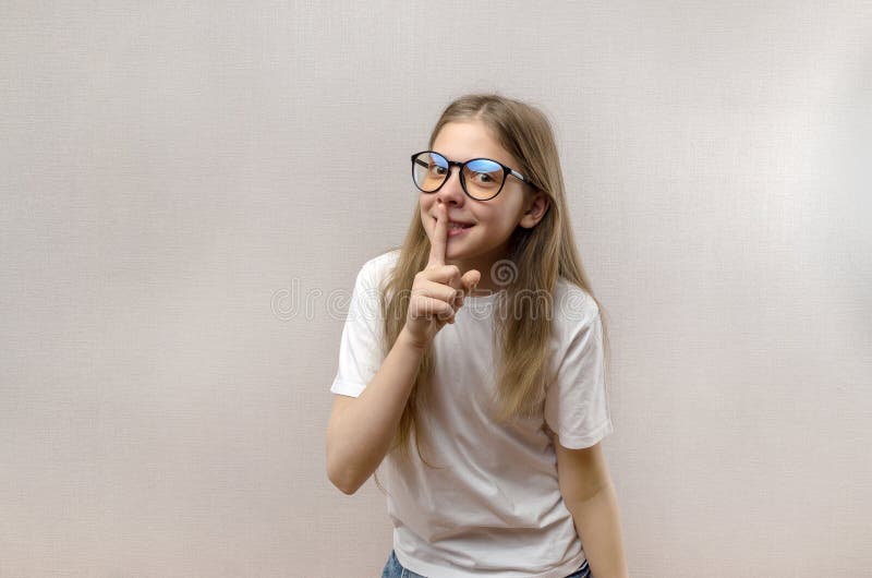 Beautiful blonde girl holding finger near lips. quiet and shh gesture. Close-up royalty free stock photos Beautiful blonde girl holding finger near lips. quiet and shh gesture. Close-up royalty free stock photos