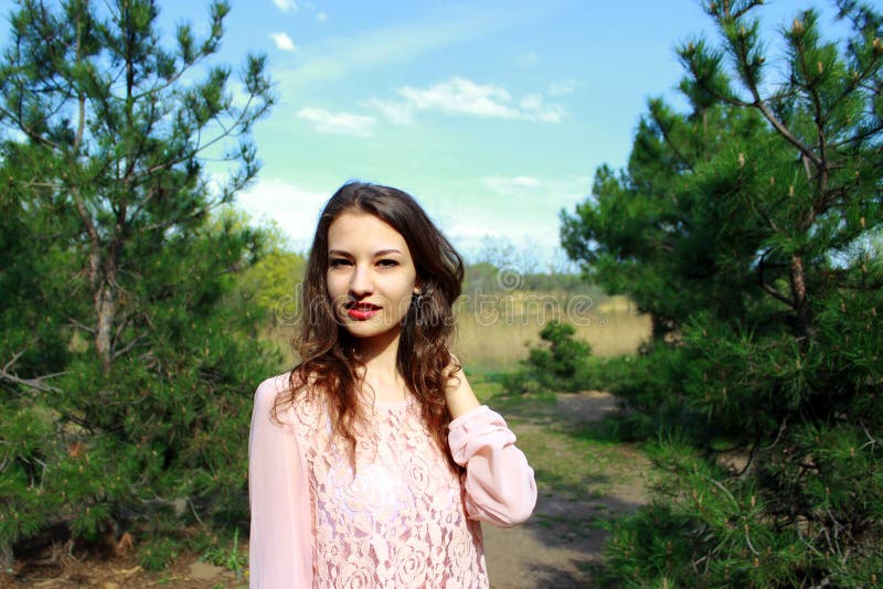 Beautiful blonde girl in a pink dress, nature background. royalty free stock images Beautiful blonde girl in a pink dress, nature background. royalty free stock images