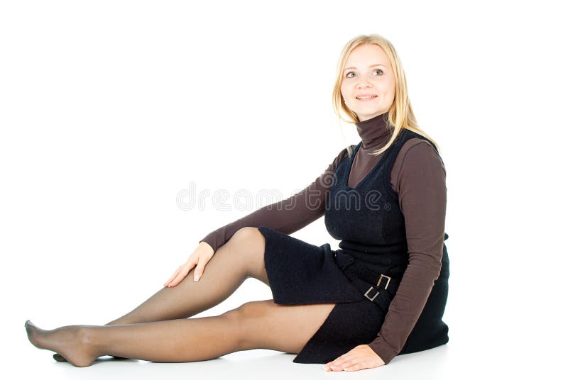 Beautiful blonde girl sitting isolated