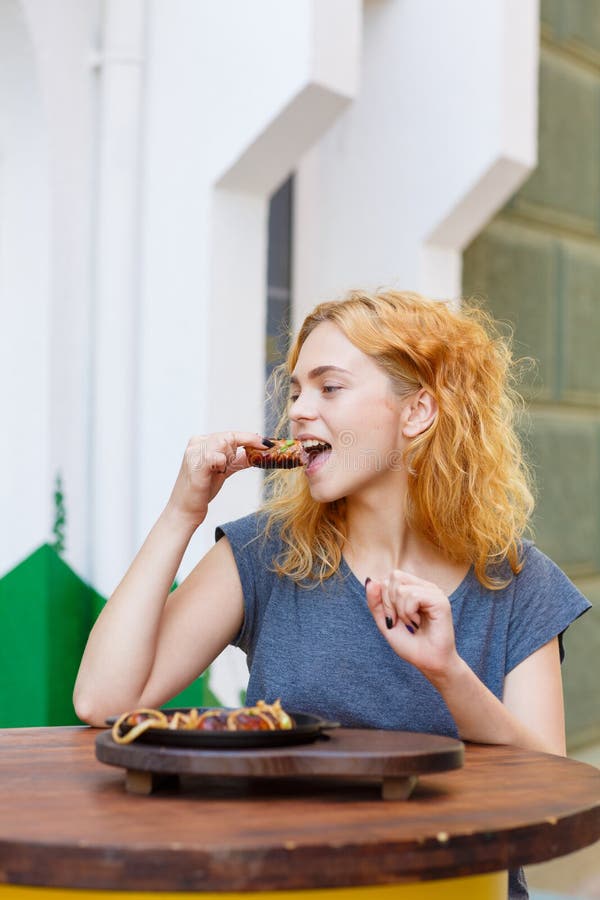 woman eating sausage