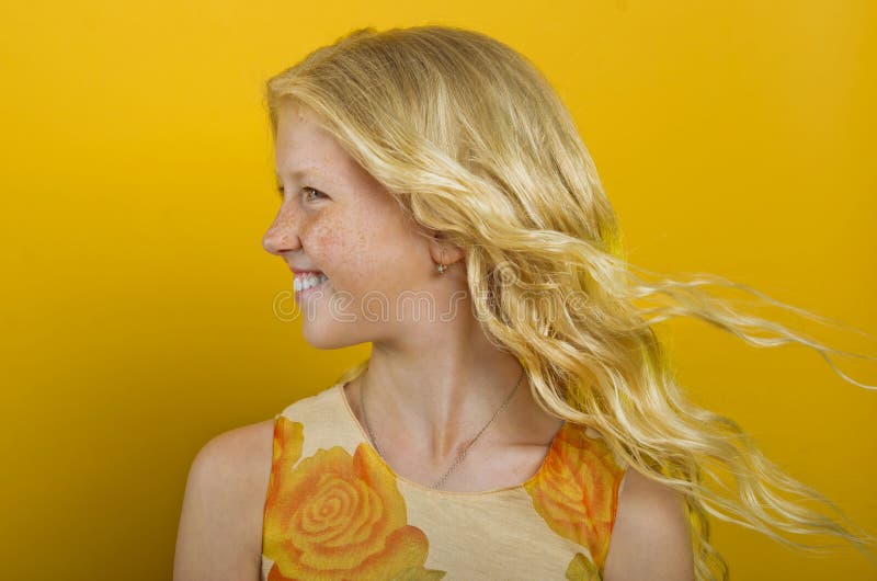 Beautiful blonde girl on a yellow background