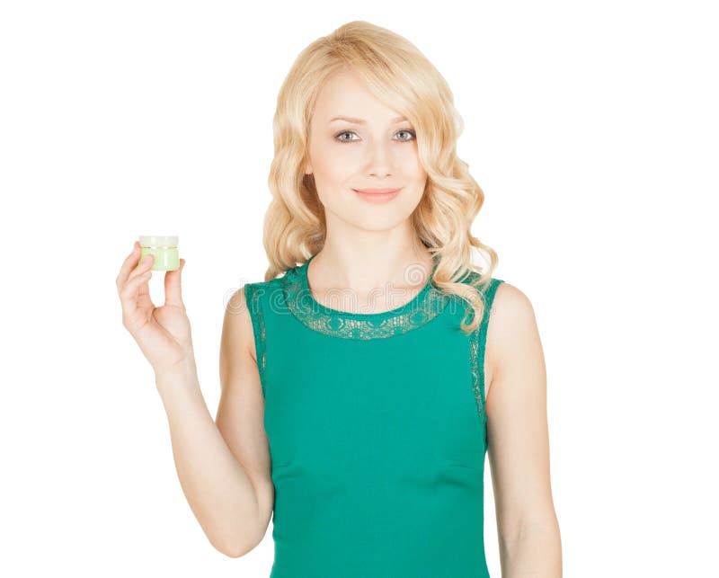 Beautiful blonde holds a cream jar in a hand