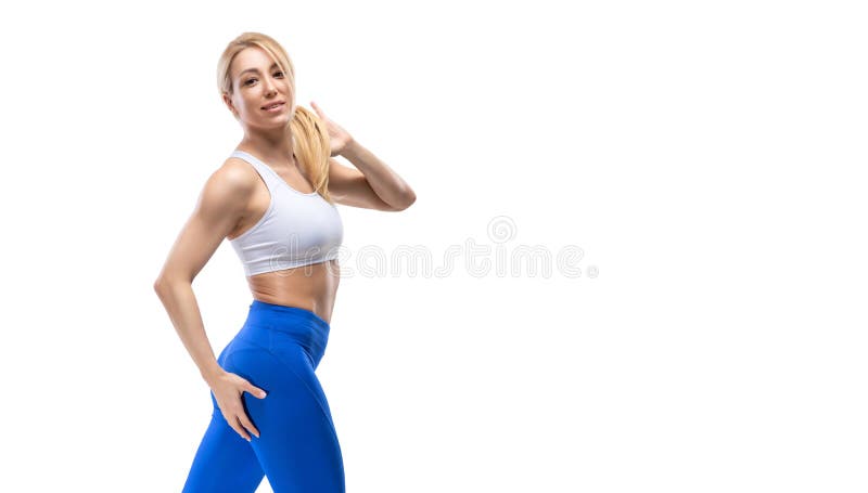 Beautiful blonde sexy girl with muscular body posing, isolated on white background. Fitness concept, woman, studio, muscle, confidence, trainer, motivation, diet, figure, sportswear, activity, clothing, copyspace, isolation, portrait, perfect, torso, abs, bodybuilding, athletic, strength, model, hair, lifestyle, female, slim, workout, health, exercise, young, strong, shape, training, gym, attractive, beauty, people, athlete, sporty