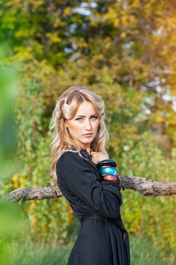 Beautiful blonde woman in black dress stock image Beautiful blonde woman in black dress stock image
