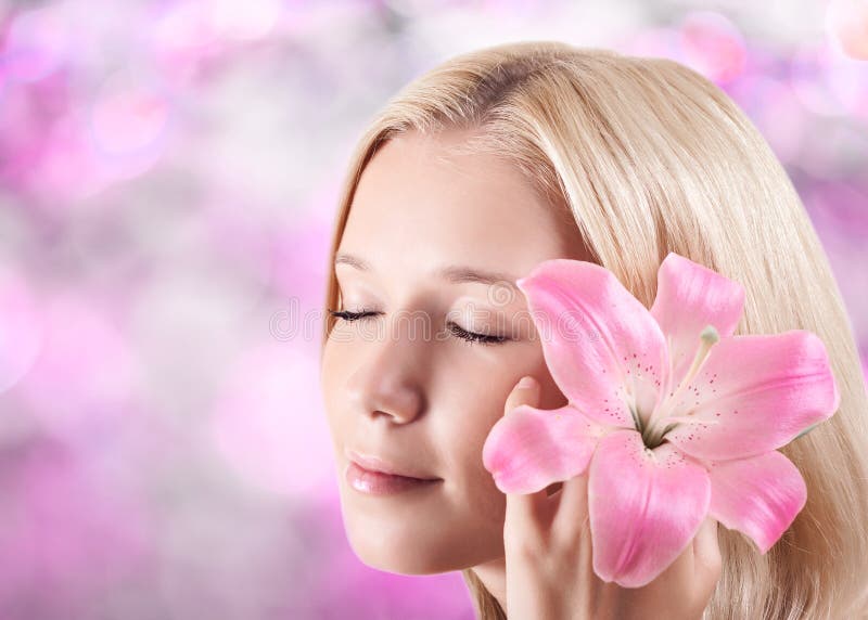 Beautiful blonde woman with lily flower stock photography