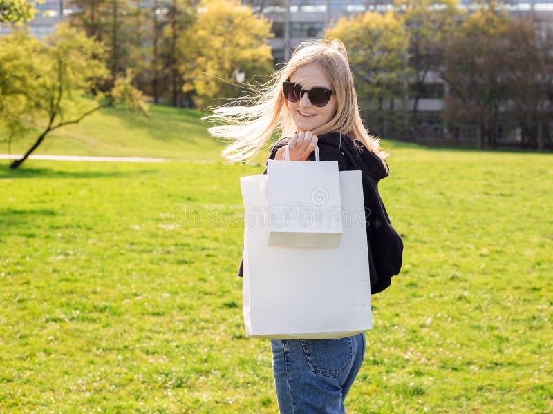 Beautiful blonde woman with sunglasses enjoys the shopping. Consumerism, shopping mock up, lifestyle concept royalty free stock photo Beautiful blonde woman with sunglasses enjoys the shopping. Consumerism, shopping mock up, lifestyle concept royalty free stock photo