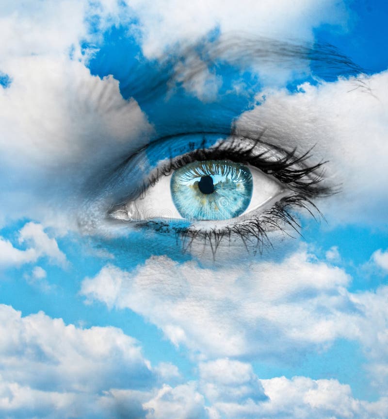 Beautiful blue eye against blue clouds - Spiritual concept royalty free stock image Beautiful blue eye against blue clouds - Spiritual concept royalty free stock image