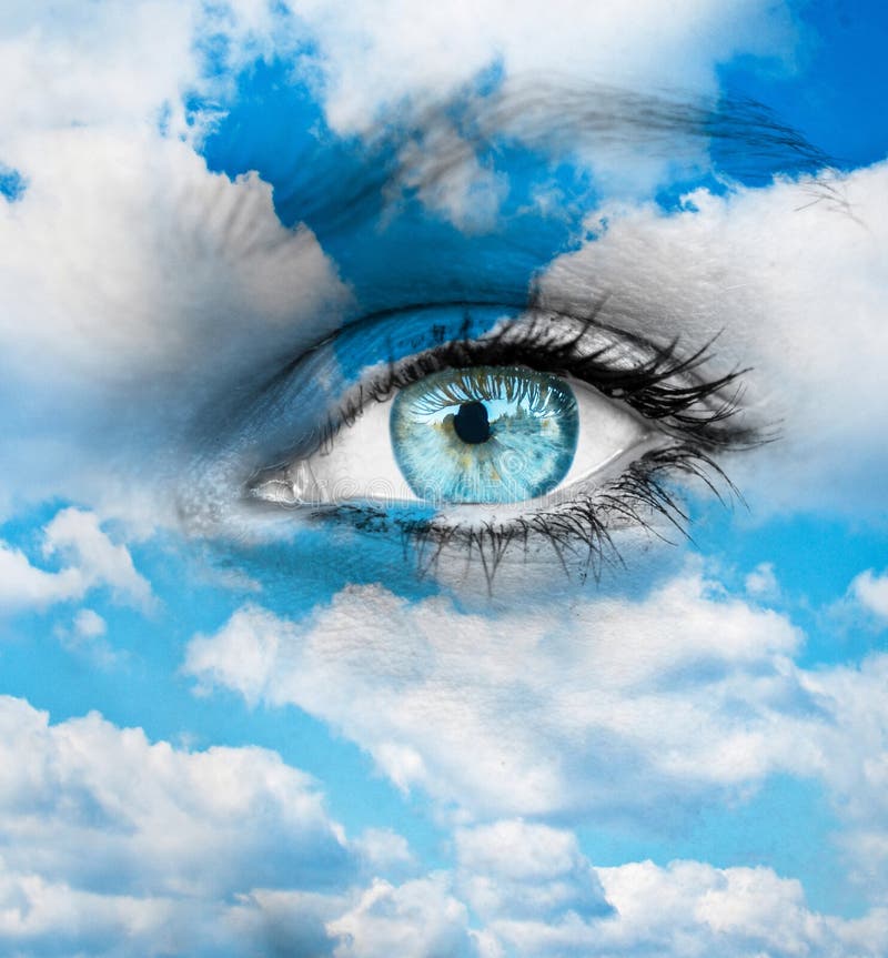 Beautiful blue eye against blue clouds - Spiritual concept