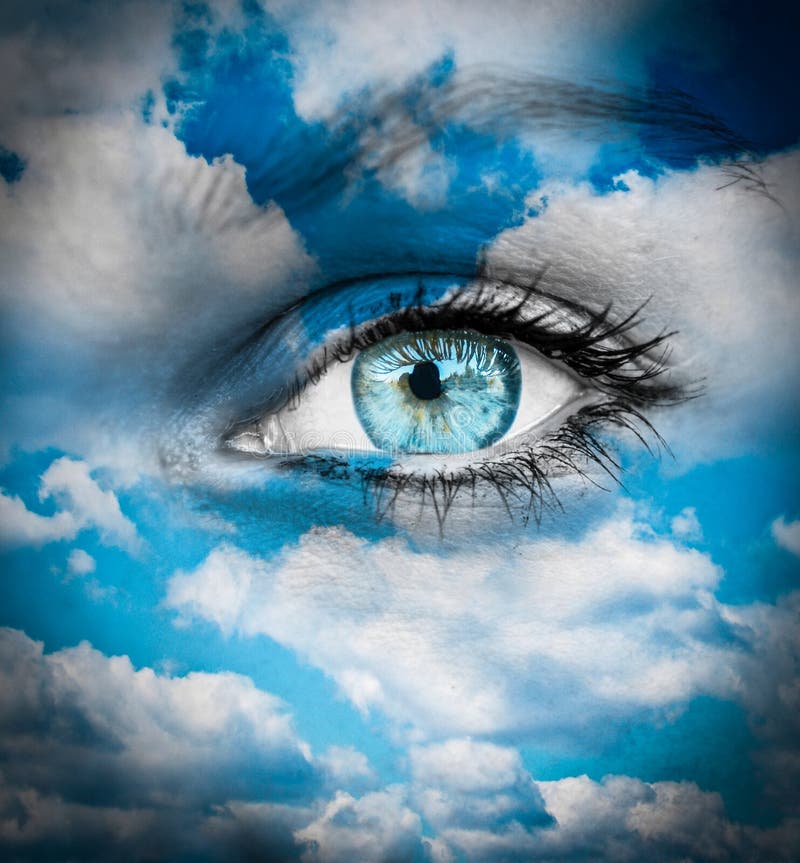 Beautiful blue eye against blue clouds - Spiritual concept